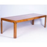 AN ART DECOR BLOND WOOD EXTENDING DINING TABLE The veneered top with cross-banded edge above the