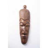 AN AFRICAN WOODEN MASK 68cm high, 20cm wide