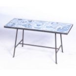 A TABLE INLAID WITH HANDMADE TILES The 12 blue and white hand painted tiles inlaid into a metal