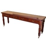 A REGENCY-STYLE MAHOGANY SERVING TABLE The rectangular top with rounded corners above four