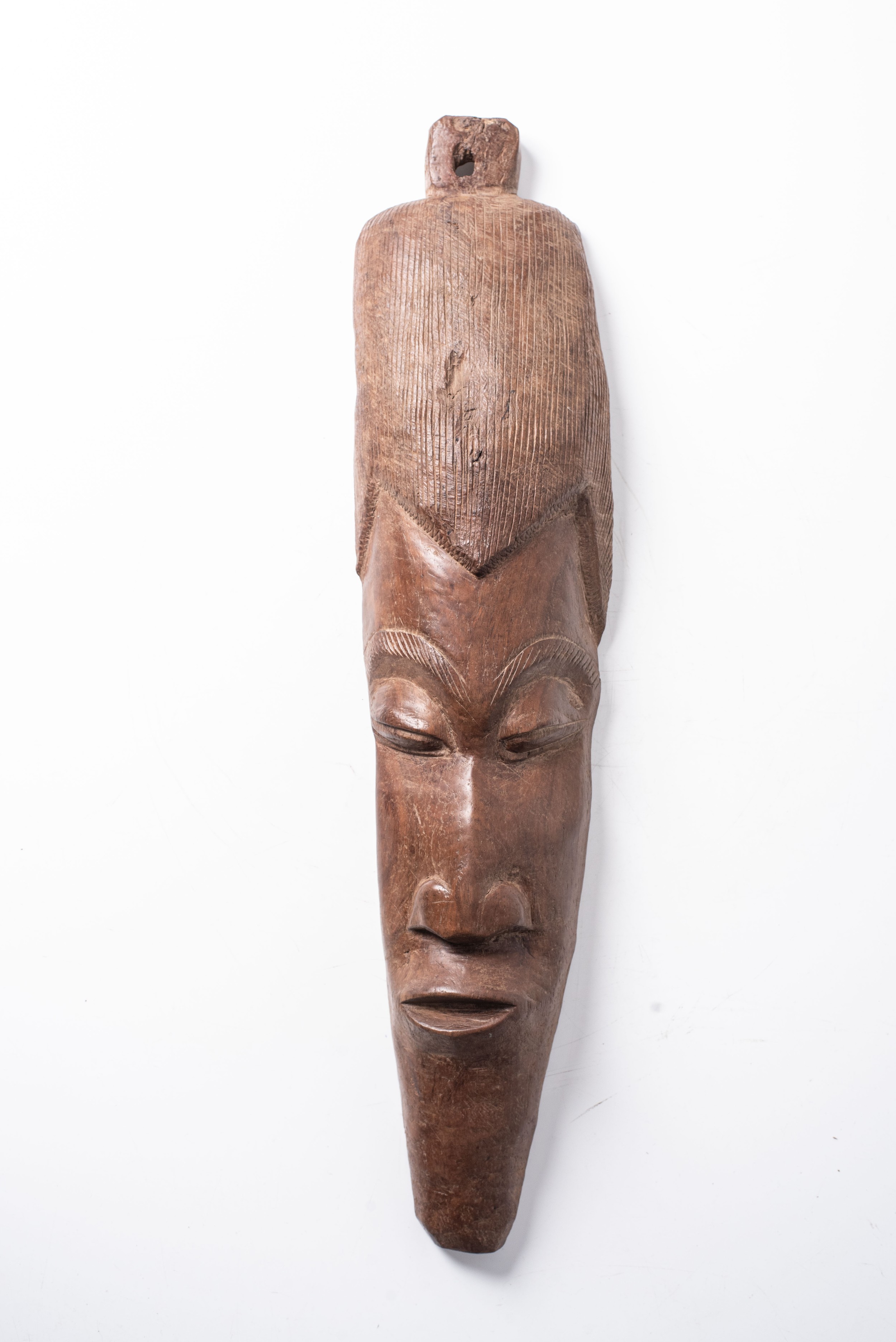AN AFRICAN WOODEN MASK 70cm high, 22cm wide