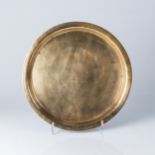 A CHINESE BRASS TEA TRAY The circular tray with a raised rim, the interior chased with figures