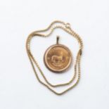 A ONE OUNCE KRUGERRAND PENDANT 1974 Bezel-set in a 14ct gold pendant, with a 14ct gold box chain,