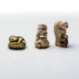 A JAPANESE IVORY 'KAPPA' NETSUKE The mythological Kappa seated atop a lotus leaf, all stained green;