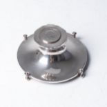 A CIRCULAR SILVER INKWELL Harrison & Son, Birmingham 1910, the hinged lid inset with a George III