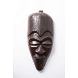 AN AFRICAN WOODEN MASK 65cm high, 30cm wide