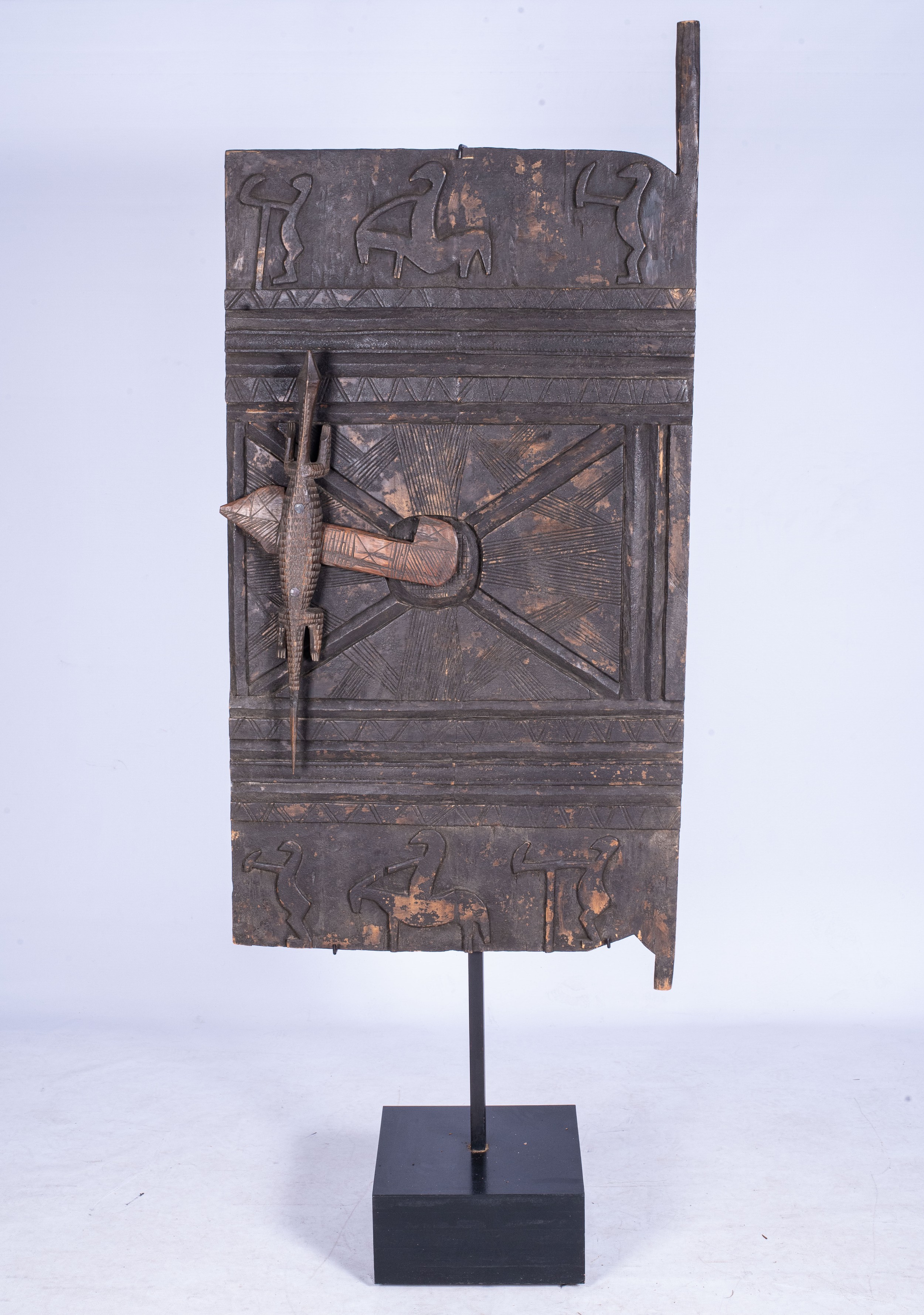 A DOGON STYLE GRANARY DOOR The door carved with figures, the handle carved as a crocodile 210cm