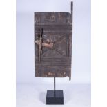 A DOGON STYLE GRANARY DOOR The door carved with figures, the handle carved as a crocodile 210cm