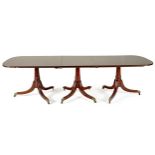 A REGENCY MAHOGANY THREE PEDESTAL EXTENDING DINING TABLE