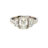 A DIAMOND TRILOGY RING, BROWNS