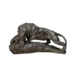 A BLACK PATINATED PLASTER FIGURE OF A LION