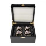 A CASED SET OF FOUR RHODIUM-COATED NAPKIN RINGS, ISABELLA ADAMS