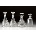 FOUR CRYSTAL DECANTERS AND A SET OF FOUR SILVER DECANTER LABELS