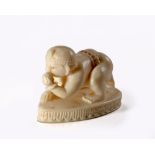 AN INDIAN IVORY CARVING OF KRISHNA AS AN INFANT, EARLY 20TH CENTURY