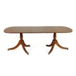 A REGENCY STYLE MAHOGANY EXTENDING DINING TABLE