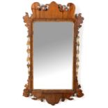 A GEORGE III WALNUT FRET-CUT MIRROR