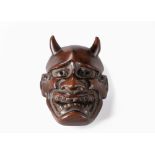 A JAPANESE HARDWOOD "HANNYA MASK" NETSUKE, MEIJI PERIOD, 1868 - 1912