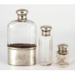 SILVER AND GLASS FLASK AND TWO SILVER-MOUNTED DRESSING TABLE BOTTLES