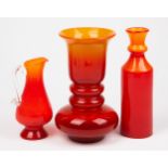 A GROUP OF THREE ORANGE AND RED GLASSWARE
