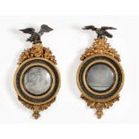 A PAIR OF REGENCY EBONISED AND GILTWOOD CONVEX MIRRORS