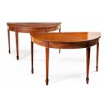 A PAIR OF GEORGE III MAHOGANY DEMI-LUNE TABLES