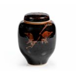 TIM MORRIS (SOUTH AFRICAN 1941 - 1990): A PORCELAIN JAR AND COVER UNDER A TENMOKU GLAZE