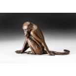 A DONALD GREIG BRONZE OF A SEATED BABOON, 2009