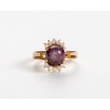 A PINK-PURPLE STAR SAPPHIRE AND DIAMOND RING