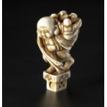 A JAPANESE MARINE TUSK "HOTEI AND BOYS" NETSUKE, MEIJI PERIOD, 1868 - 1912