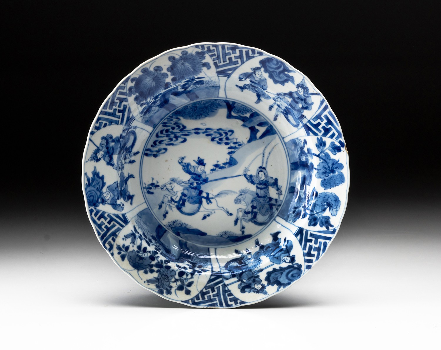 A CHINESE BLUE AND WHITE "WARRIORS" BOWL, QING DYNASTY, 18TH CENTURY