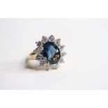 18ct Sapphire and Diamond Ring, claw set 12 diamonds surrounding. S5.10 ct D1.70