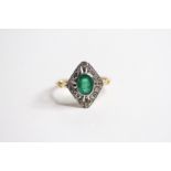 18ct Emerald and diamond small plaque ring with fleur-de-lis style split shoulders. Oval bezel set