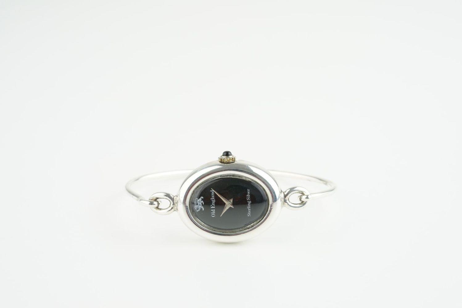 LADIES OLD ENGLAND STERLING SILVER WRISTWATCH, oval black dial with no hour markers and dauphine