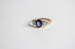 18ct Sapphire and Diamond 3 stone ring central oval sapphire bezel set in yellow gold, two outer