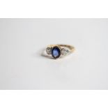 18ct Sapphire and Diamond 3 stone ring central oval sapphire bezel set in yellow gold, two outer