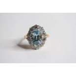 18ct Oval aquamarine and diamond cluster ring 10 diamonds in surround claw set. A3.80 D2cts