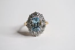 18ct Oval aquamarine and diamond cluster ring 10 diamonds in surround claw set. A3.80 D2cts