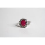 18ct Oval Ruby and Diamond Ring, with drop lock baguette style shoulders Ruby 2.47 D0.73 marked 750