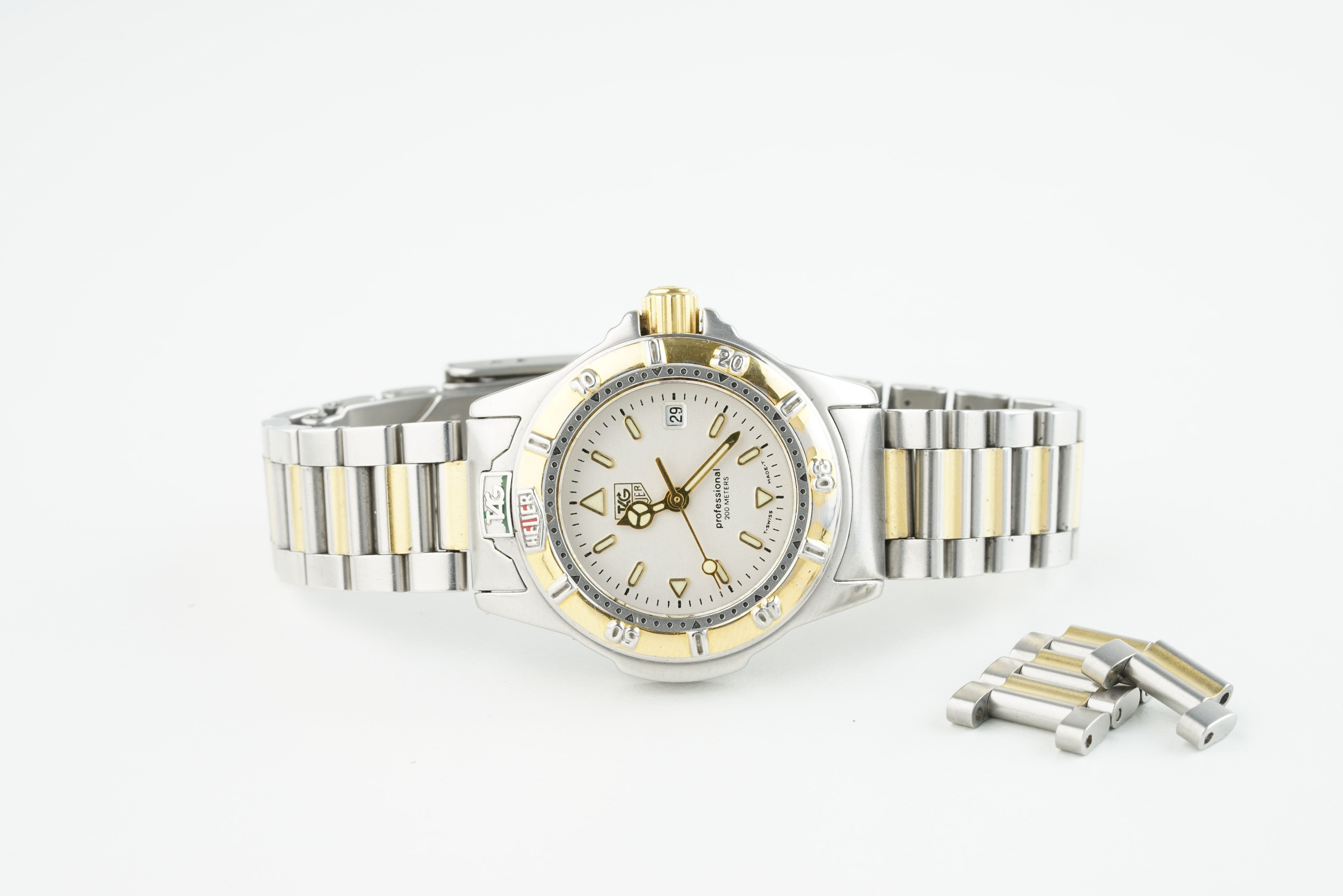 LADIES TAG HEUER PROFESSIONAL WRISTWATCH, circular white dial with applied hour markers and hands,