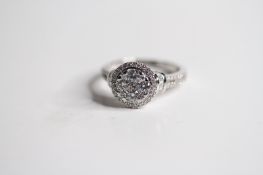 18ct illusion set round halo ring with baguette cuff shoulders. TDW1.13ct 5.05G