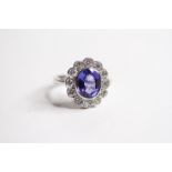 18ct Oval bezel set tanzanite and diamond cluster ring, 12 diamonds in the outer cluster TZ Est