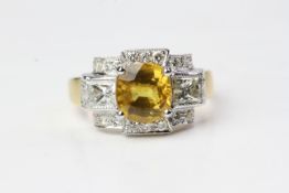 Yellow sapphire and diamond ring. Central yellow sapphire with 2 x princess cuts to each side in a