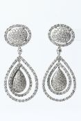 18WG Large pave set pear shaped domes with double moveable halos suspended from an oval pave set
