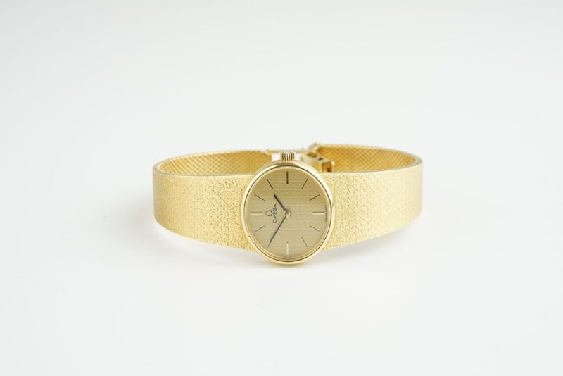 LADIES OMEGA 18CT GOLD COCKTAIL WATCH, oval gold dial with stick hour markers and hands, 22mm 18ct