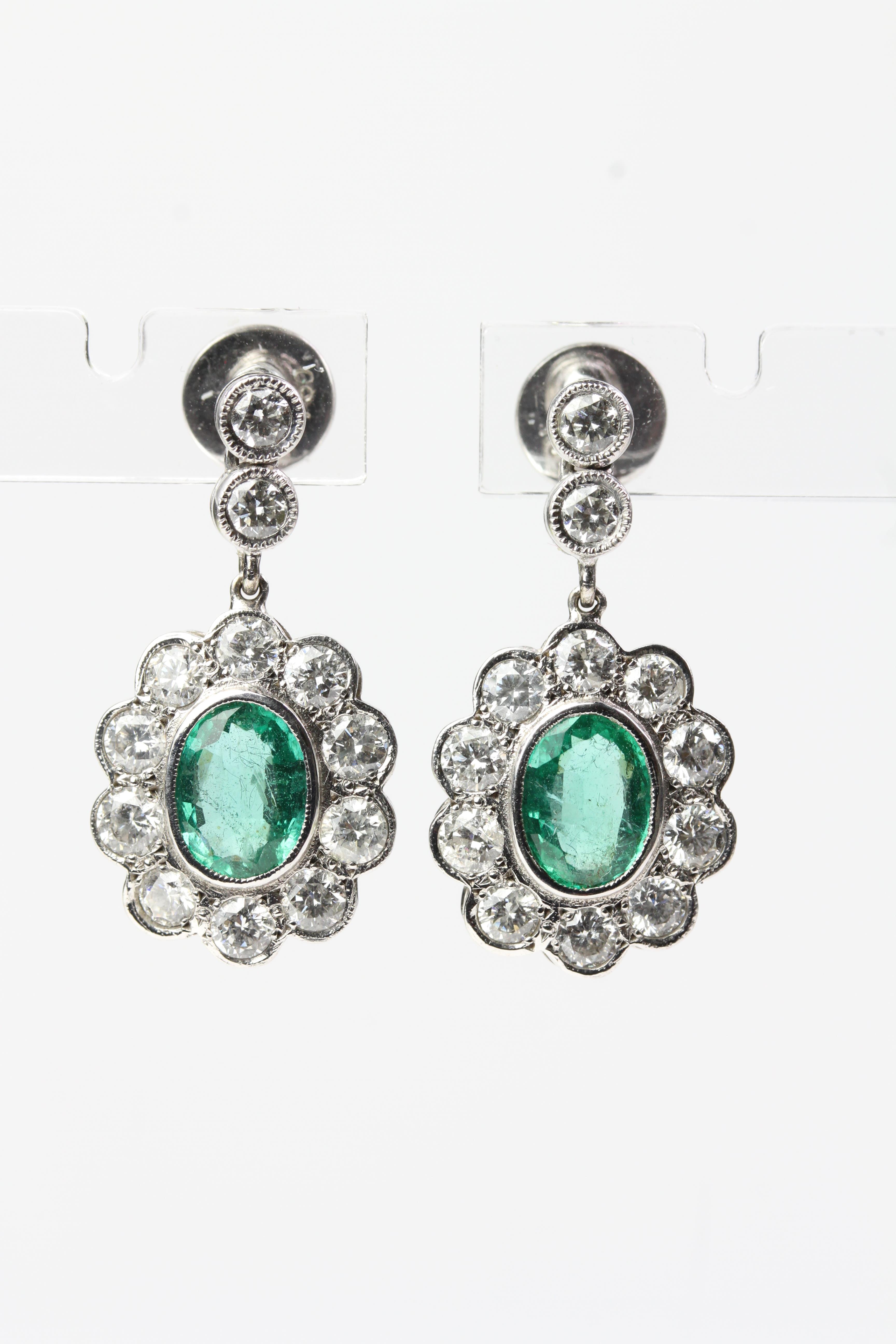 18WG Oval emerald and diamond cluster drop earrings suspended on 2 bezel set diamonds E 3.03 D2.01