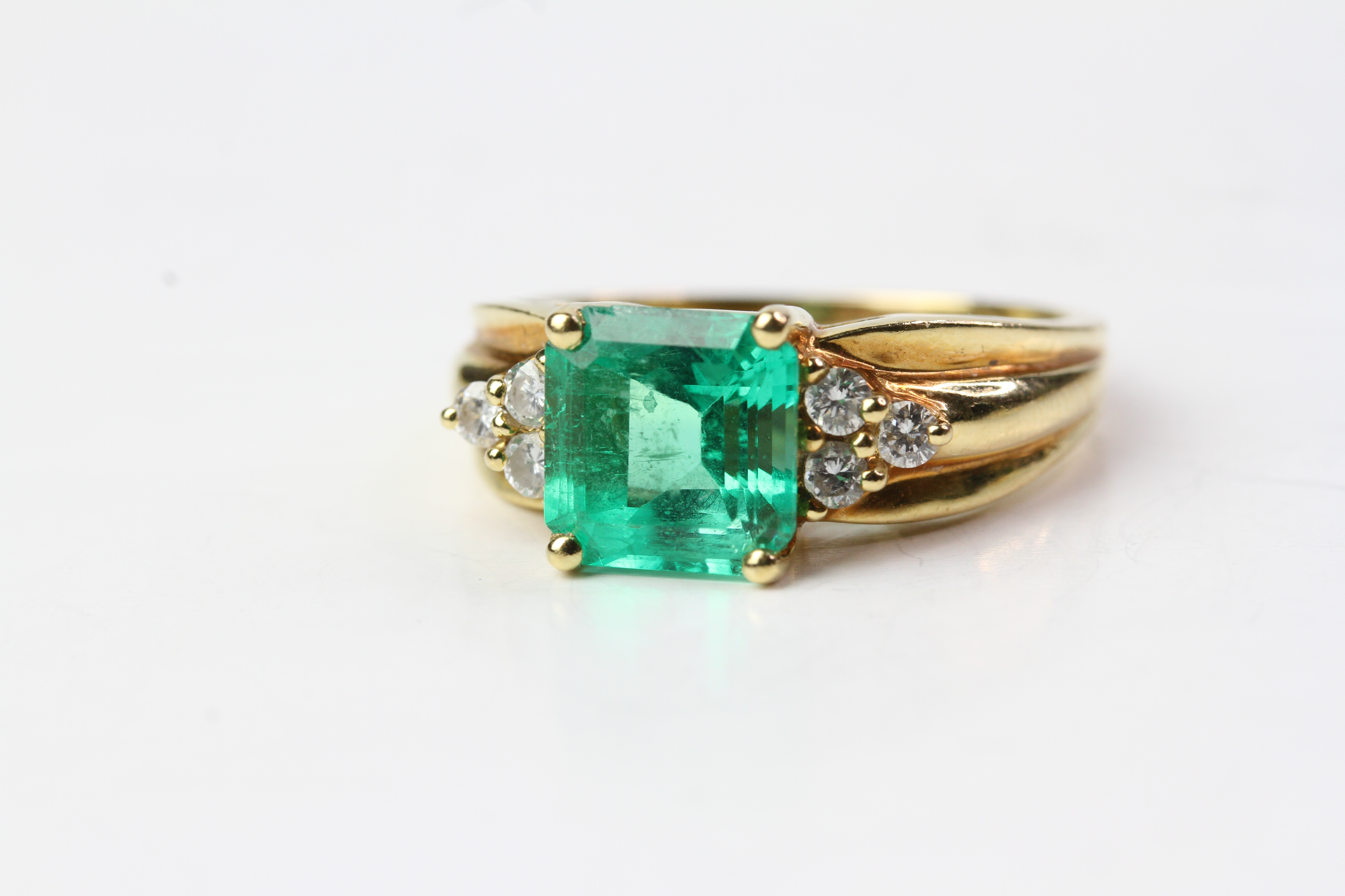 18YG Emerald and diamond ring, Square step cut emerald with 3 brilliant cut diamonds each side. (