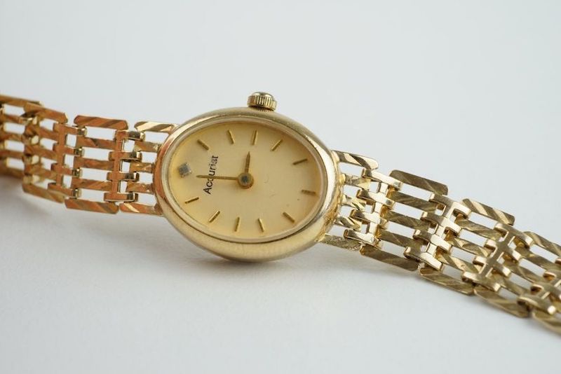 LADIES ACCURIST 9CT GOLD COCKTAIL WRISTWATCH, oval champagne dial with stick hour markers and hands,