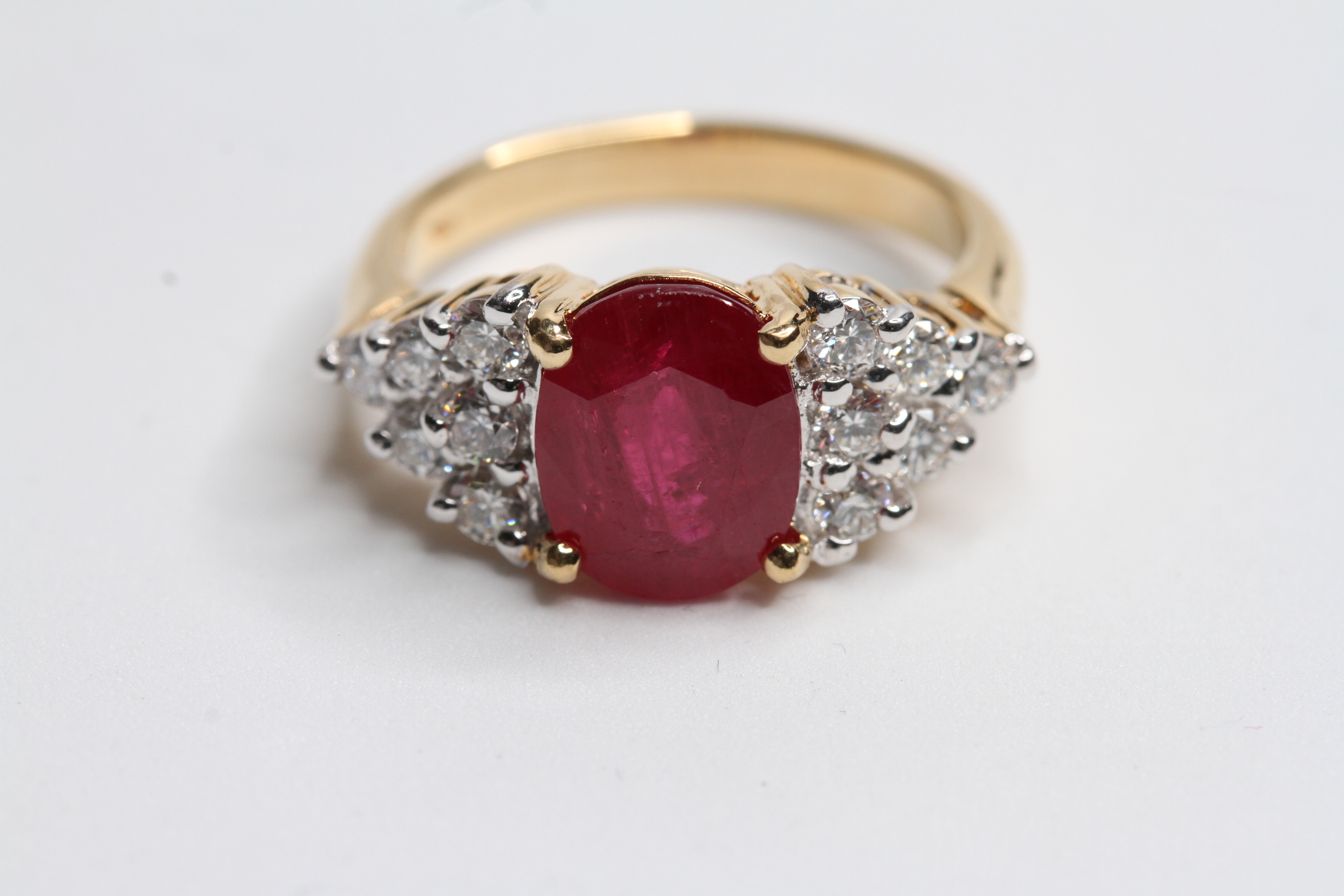 18YG 4 claw set oval ruby ring with triangular diamond set shoulders R3.69 D0.60 Ruby is flux