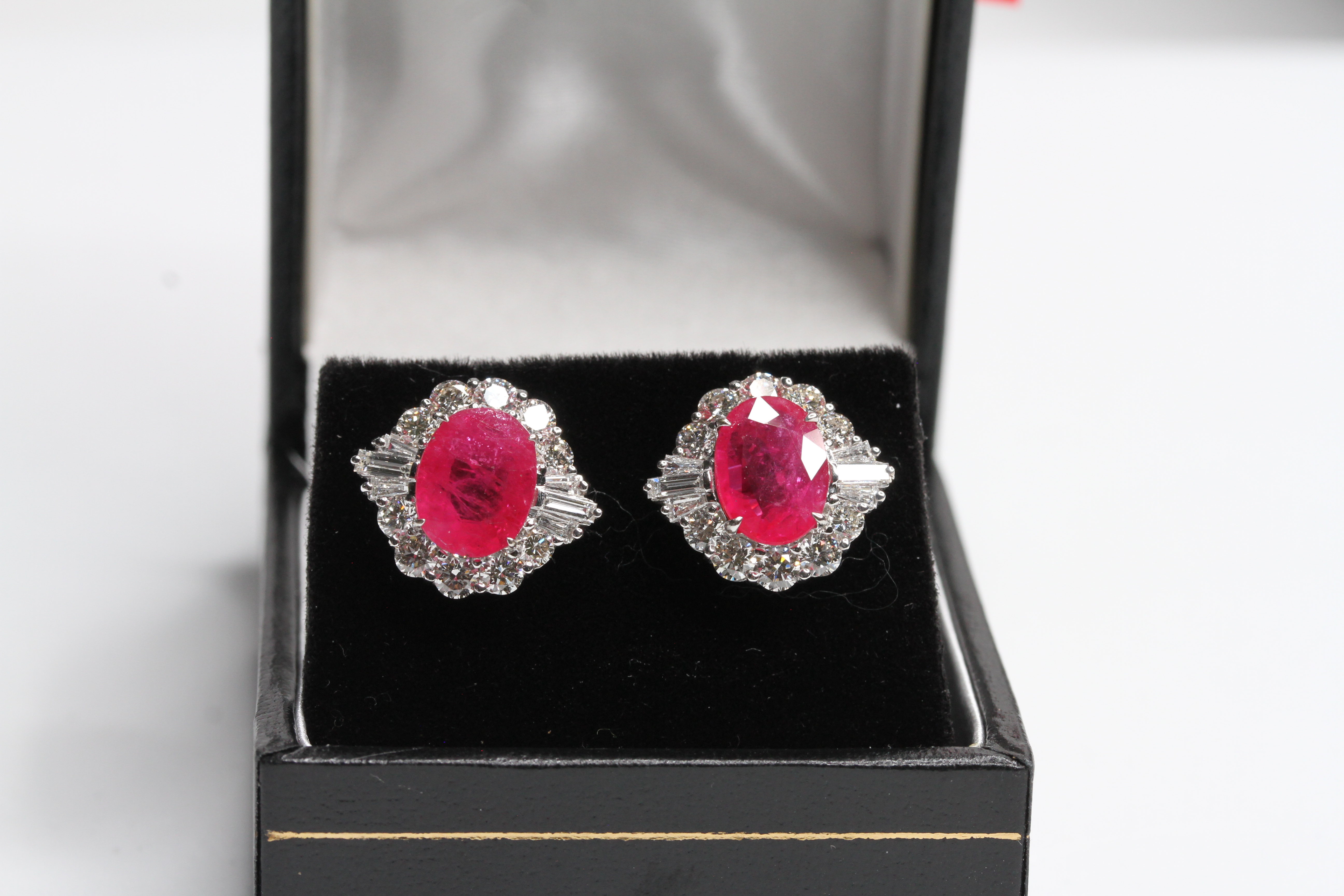 18WG Oval ruby and diamond cluster earrings with baguettes at the halfway point. R3.82/1.63 double
