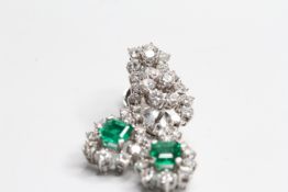 18WG Emerald and diamond long drop cluster earrings. Est. E2cts Est D3cts. 7 diamond cluster with